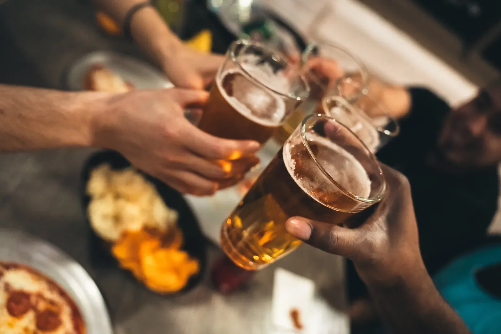 A bar with people serving drinks
