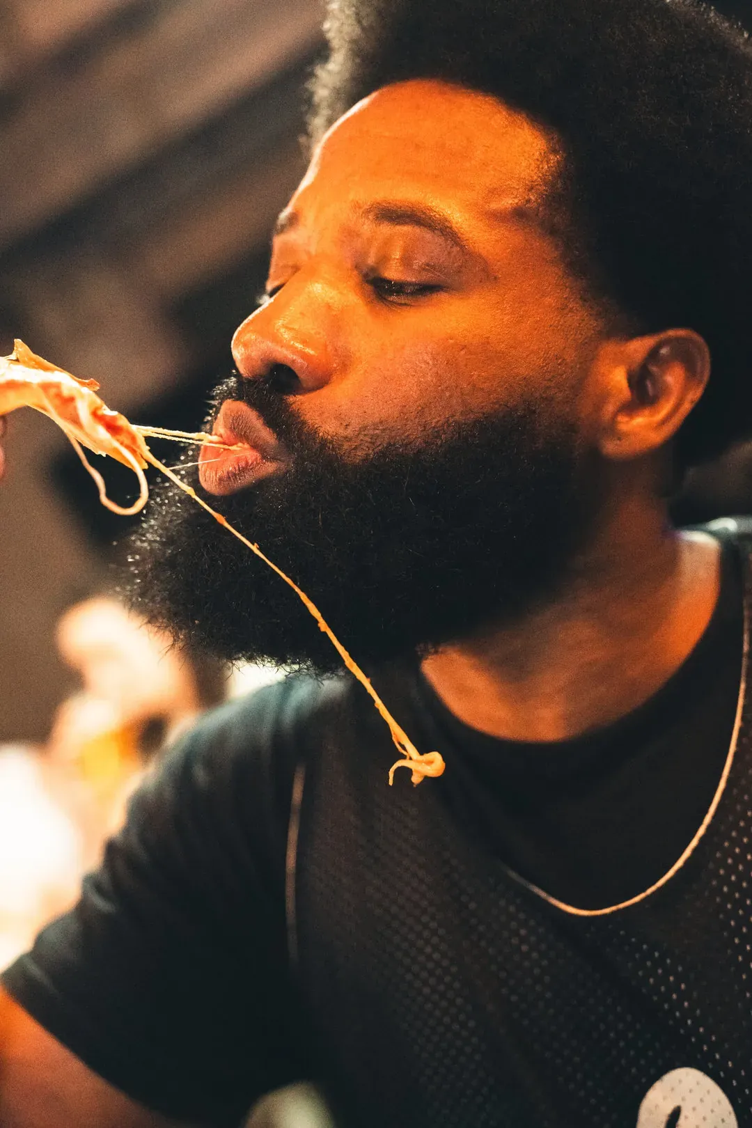 A man eats a pizza