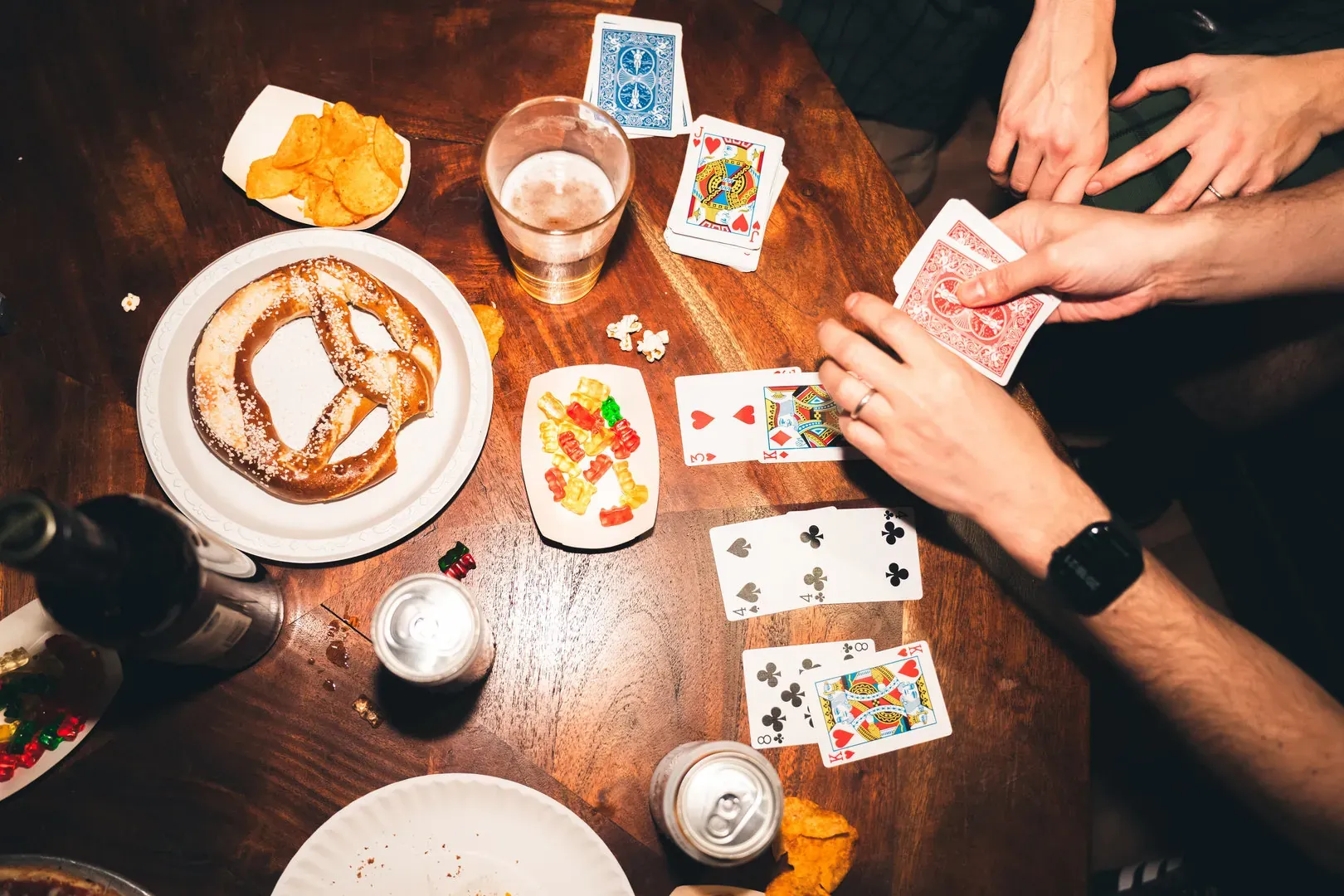 Friends playing cards over a drink